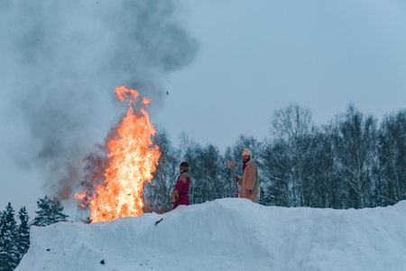 Moscow Region, Russia - February 18, 2018: Celebration of Russian Shrovetide. Burning of scarecrow for the honor of winter end.のeditorial素材