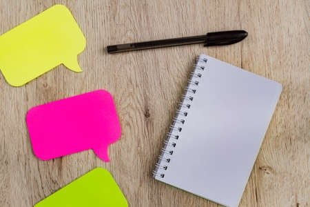 Business and office concept - blank notebook and stickers on wooden table. Minimal flat lay, top...