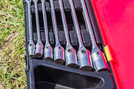 set of socket wrenches in a case, close up of workers tools, selective focus