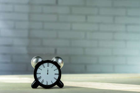 Alarm clock decoration figure on wooden table. Copy space for text
