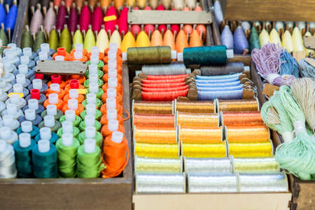 Assortment of multicolored thread spools for sewingの写真素材