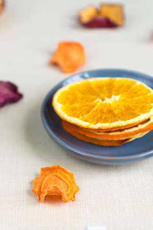 Healthy food organic nutrition. Sliced and dried apple, orange, carrot and beetroot on textile background.の写真素材