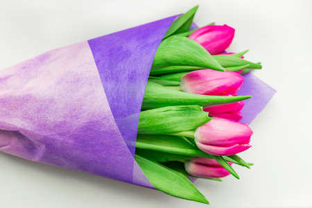 Beautiful spring bouquet of pink tulips on white backgrounsd. Top view.の写真素材