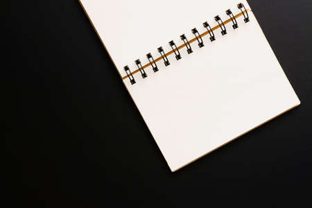 Design concept - Top view of empty kraft notebook on black background. mock up.の写真素材
