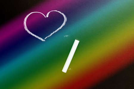 A chalk board with the drawn heart. Rainbow Background texture with copy spaceの写真素材