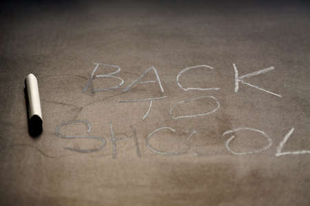 Back to school background. White chalk text on school blackboard. Shallow depth of fieldの写真素材