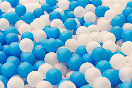 Close up of plastic white and blue balls in dry pool on the playgroundの写真素材