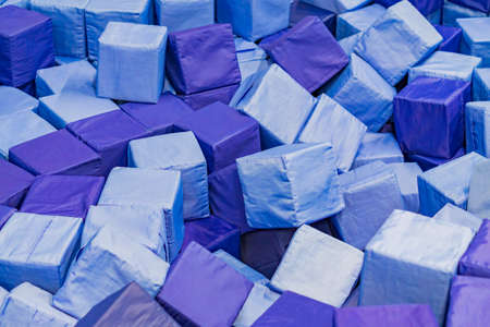 Plenty of soft blue blocks in a kids' dry pool at playground. geometric toys.の写真素材