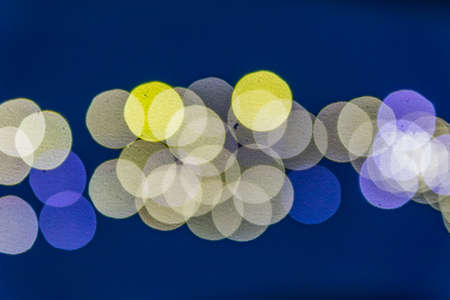 abstract blurred lights on background in blue and yellow- christmas celebration concept