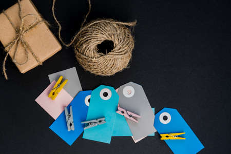 Handcrafted gift boxes wrapped in Craft paper with paper card tag, rope and wooden clothespins for...