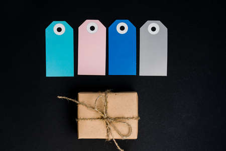 Handcrafted gift boxes wrapped in Craft paper with blue and pink paper card tag, rope for...