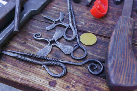 blacksmith tools and workplace: anvil, hammers, blacksmith tongs, firesteel.