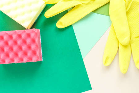 top view of yellow rubber gloves and two sponges on multicolored bright background with copy spaceの写真素材