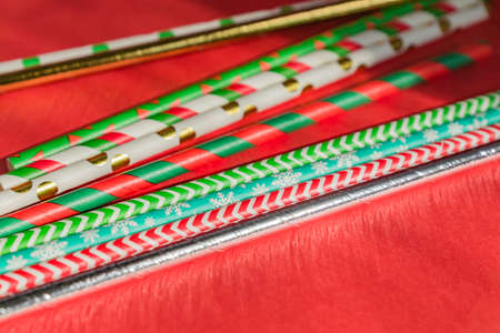 New Year Christmas background. Celebration drinking cocktail party straws ion red background....