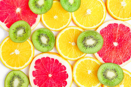 close up of citrus slice, kiwi, oranges and grapefruits isolated on white background. Fruits backdropの写真素材