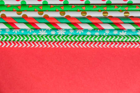 New Year Christmas background. Celebration drinking cocktail party straws ion red background....