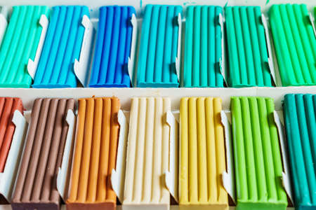 Pastel colors of modeling clay. Multicolored plasticine bars ina box, background texture
