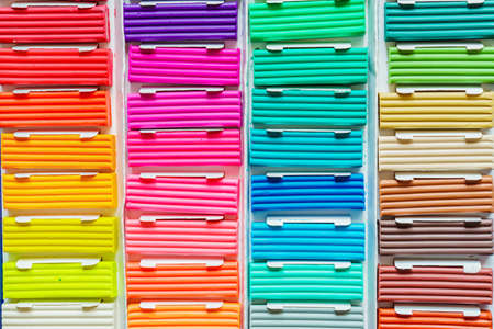 Rainbow colors of modeling clay. Multicolored plasticine bars ina box, background textureの写真素材