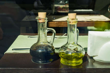 olive oil and balsamic vinegar served on a wooden table in the cafe