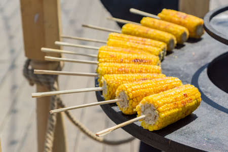 close up of grilled sweet corn on sticks. Street foodの写真素材