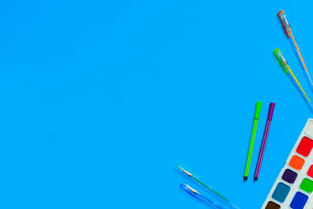 stationery accessories - pens, markers, paints on blue background. Composition mock-up, Back to school concept with office supplies. Top viewの写真素材