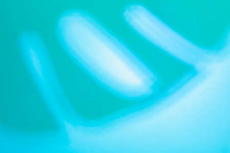 Top view of tropical leaf Monstera shadow on neon blue background. Flat lay. Summer concept with...