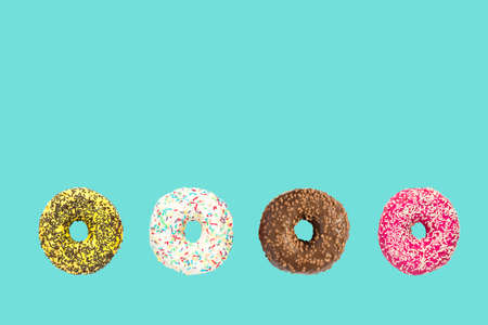 multicolored frosted donuts with colorful sprinkles and hazels on blue background.