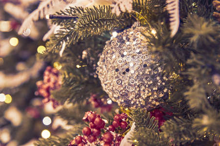 close up of christmas tree decorated with silferr sparkling balls and garland with lights on. Festive background with copy space for your projectsの写真素材