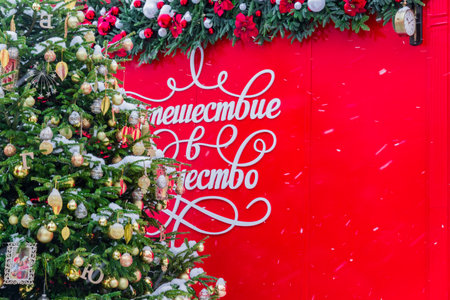 Moscow, Russia - December 2018 - Inscription in Russian "Journey to Christmas" festival framed with christmas tree and garland. Street holiday decorationのeditorial素材
