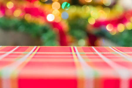 red gift box on christmas tree background. Christmas and New Year concept.