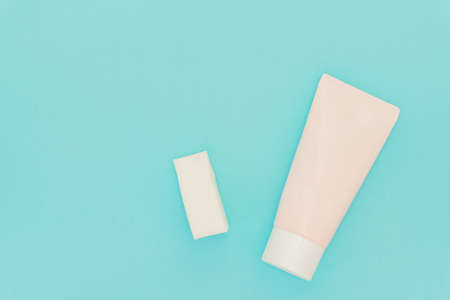 Face foundation application sponges and pink tube with liquid foundation on blue backgroundの写真素材