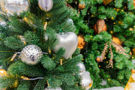 Christmas and New Year holidays background. Christmas tree decorated with silver balls and hearts....