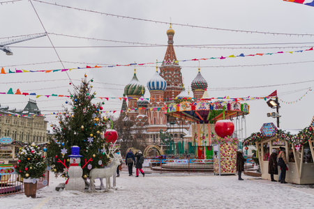 Moscow, Russia - December 20, 2018: Christmas decorations on Red Square in Moscow on background of St. Basil's Cathedral. Winter holiday postcard from Red Square under snowfall.のeditorial素材