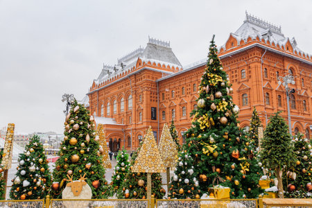 Moscow, Russia - December 20, 2018: Christmas decorated Manezhnaya Square in a snowy day. Many christmas trees on Red Square backgroundのeditorial素材