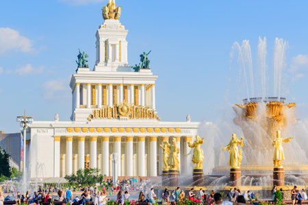 MOSCOW, RUSSIA - August 20, 2019: Fountain Friendship of the people and Central Pavillion at VDNH park in Moscow against blue sky at sunny summer dayのeditorial素材