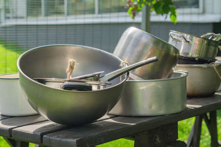 old metal kitchenware on wooden table outdoors. Countrside lifestyle.の写真素材