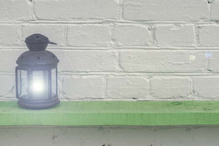 Old vintge black rusty lantern on green shelf, home interior decorationの写真素材