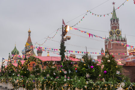 MOSCOW, RUSSIA - December 18, 2019: Christmas decorations on Red Square in Moscow on background of Spasskaya Tower. Winter holiday postcard from Red Squareのeditorial素材