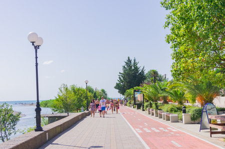 Sochi, Russia - September 07, 2019 - Black sea embankment and walking tourists in a sunny day.のeditorial素材