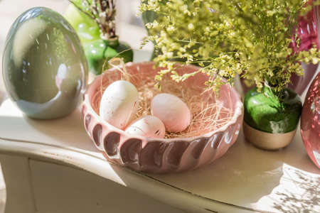 Easter interior decoration. Beatuful composition with nest, eggs, and blooming flowers.の写真素材