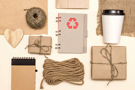 products made from recycled kraft paperand wood: packages, notebook, disposable coffee cup, wooden...