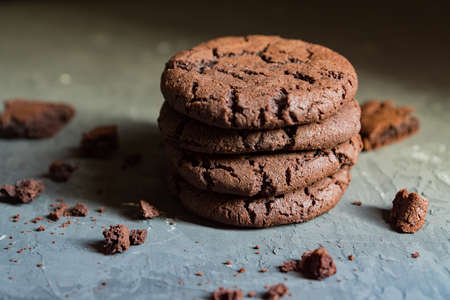 stuck of chocolate brownie cookies on black concrete background in rays of sun