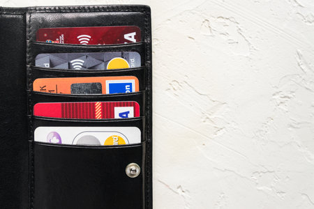 MOSCOW, RUSSIA -March 04, 2020: Illustrative Editorial e of black leather Card Holder anddifferent credit cards - Visa, Mastercard on white Background.のeditorial素材
