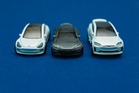 Moscow, Russia - April 14, 2020: luxury toy cars Tesla models on classic blue background. Copy...