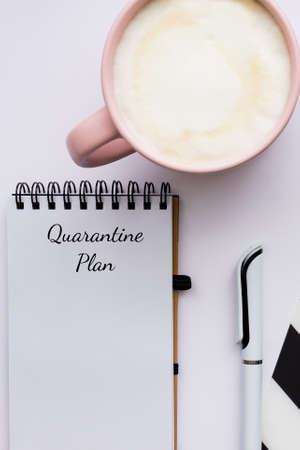 Quarantine plan while stayin home because of covid 19 pandemia. Home office layout. Notepad and cup...