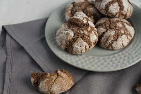 biscuits with chocolate cracks. Homemade tasty cookies in gray bowl on a table.