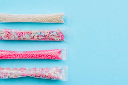 Set of sugar sprinkles of white, pink and blue colors in shape of stars, balls and butterflies....