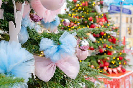 close up of christmas trees decoration with toys and garlands. City festive decor during winter holidays.の写真素材