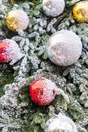 close up of christmas trees decoration with baubles and snow icing. Festive greeting card for winter holidaysの写真素材