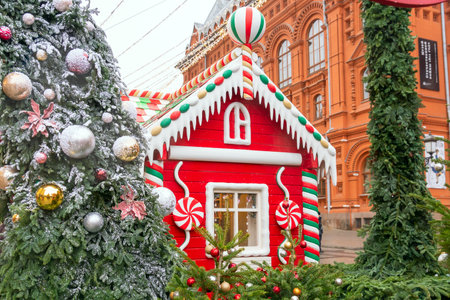 Moscow, Russia - December 18, 2019: Christmas decorated Manezhnaya Square and candy house shop. Many christmas trees on Red Square backgroundのeditorial素材